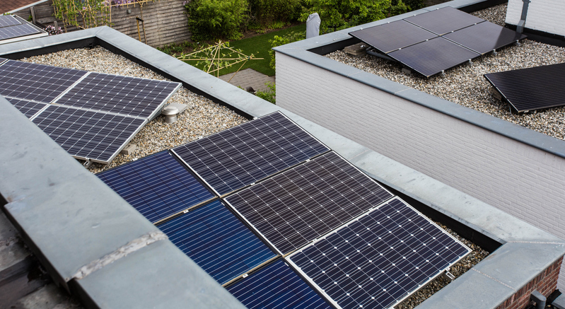Modern houses with solar panels on the roof for alternative energy. close-up